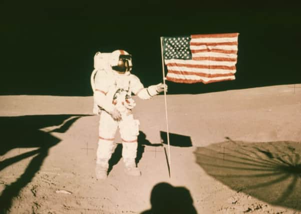 On this day in 1971 astronaut Alan B Shepard holds a US flag on the surface of the moon during the Apollo 14 mission. Picture: Getty