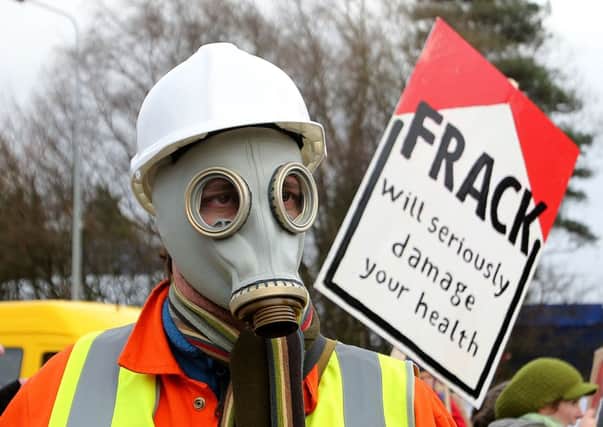 An anti-fracking protestor. MSPs voiced concern about 'radioactive' materials being flushed during methane extraction. Picture: PA