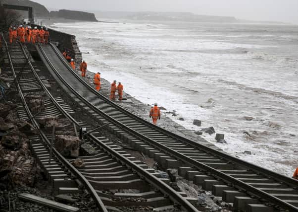 Railway workers inspect the main Exeter to Plymouth railway line that has been closed due to parts of it being washed away by the sea at Dawlish. Picture: Getty