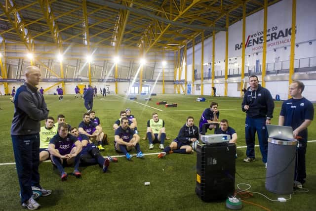 Duncan Hodge, left, talks his group of players through video footage of the Ireland game. Picture: SNS/SRU