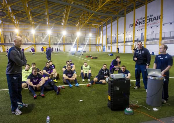 Duncan Hodge, left, talks his group of players through video footage of the Ireland game. Picture: SNS/SRU