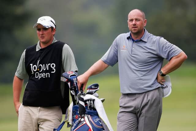 Craig Lee and his caddie gaze up the 18th fairway. Picture: Getty