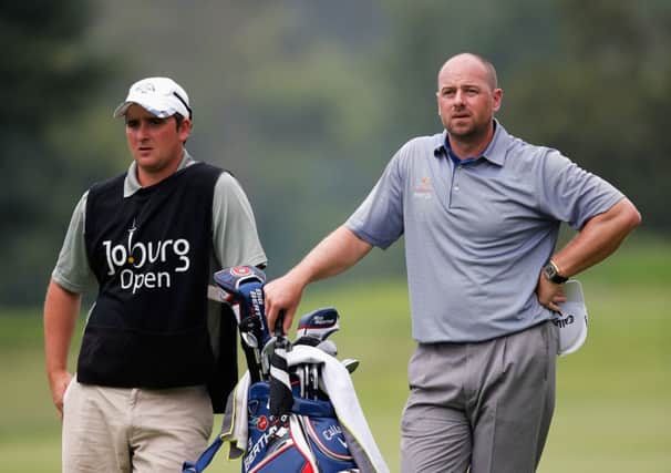 Craig Lee and his caddie gaze up the 18th fairway. Picture: Getty