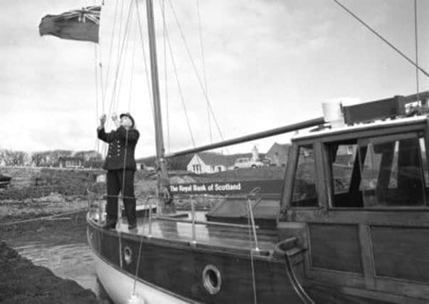 Skipper Davie Irvine on the M.V. Otter Bank at Shapinsay pier in the 1960s. Picture: Contributed