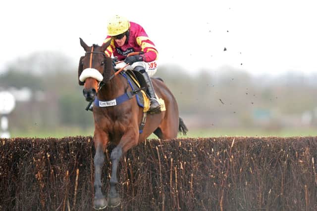 Jockey Jason Maguire riding Harry Topper on their way to victory. Picture: PA