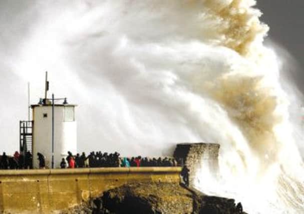 Waves crash against the harbour wall at Porthcawl in south Wales. Picture: Reuters