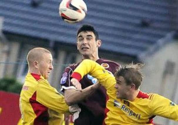 Albion and Stenhousemuir players jump for the ball. Picture: Johnston Press