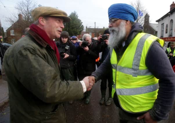 Nigel Farage meets volunteer Ravi Singh in Burrowbridge on the Somerset Levels. Picture: Getty