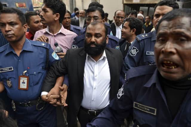Crowds watched as Delwar Hossain was escorted to court yesterday. Picture: AP