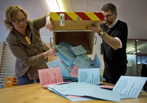 Electoral workers empty a ballot box yesterday. Picture: AP