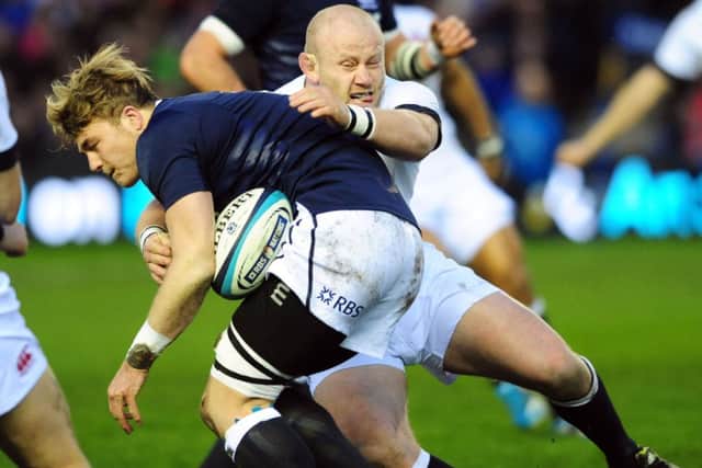 David Denton tries to burst through the tackle of Dan Cole. Picture: Ian Rutherford
