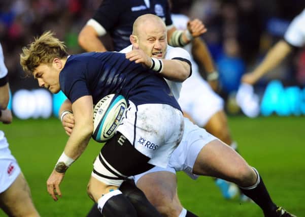 David Denton tries to burst through the tackle of Dan Cole. Picture: Ian Rutherford