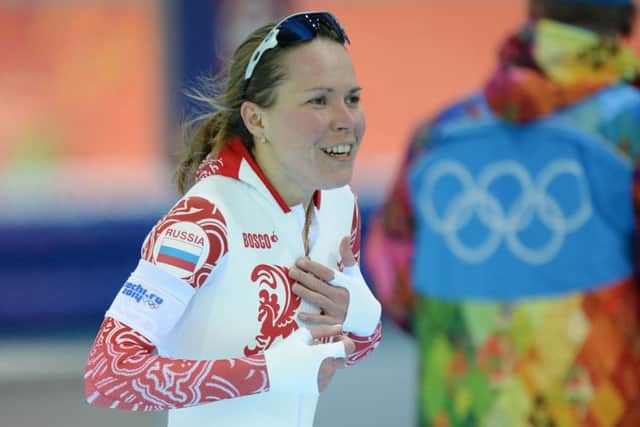 Olga Graf covers her modesty after forgetting she wearing nothing under her suit. Picture: AFP/Getty