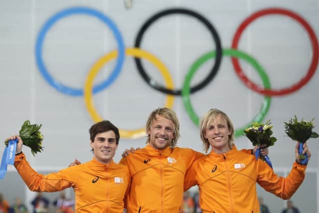 Jan Smeekens, Michel Mulder, centre, and twin brother Ronald. Picture: AP