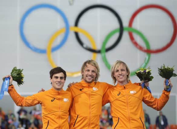 Jan Smeekens, Michel Mulder, centre, and twin brother Ronald. Picture: AP