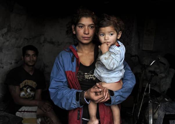 Young Roma family mother Alena Kalejova (C) posing with her baby Daniela (R) in the eastern Slovak village of Ostrovany. Picture: Getty