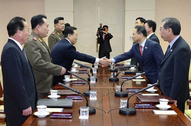 Won Tong Yon, left, shakes hands with his South Korean counterpart Kim Kyou-hyuns yesterday. Picture: AP