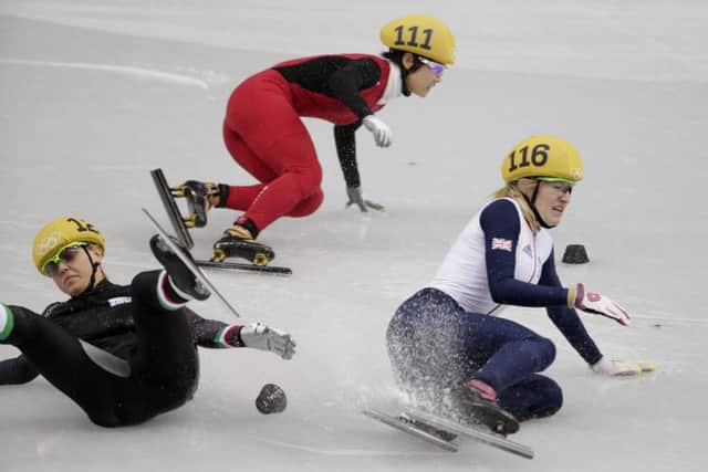 Elise Christie, right, hits the ice after a collision with Italys Arianna Fontana. Picture: AP