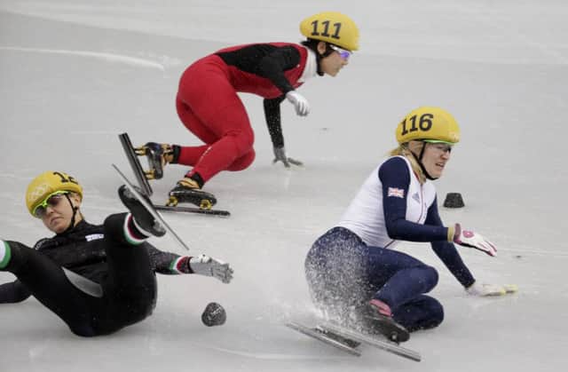 Elise Christie, right, hits the ice after a collision with Italys Arianna Fontana. Picture: AP