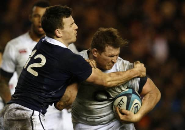 Scotland centre Matt Scott, left, tackles Englands Dylan Hartley. Picture: Reuters
