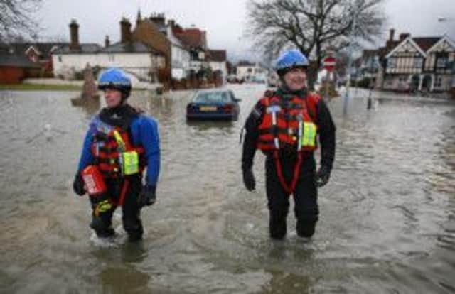 Police officers from Thames Valley's Specialist Search and Recovery Team patrol flood waters in the High Street on February 12, 2014 in Datchet, England. Picture: Getty
