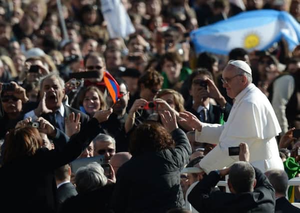 Pope Francis waves to the crowds at his inauguration mass last year. Picture: Getty