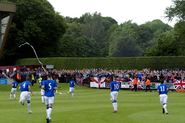 Rangers players head out in front of their supporters. Picture: SNS