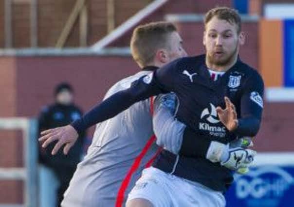 Martin Boyle, right, is hauled back by Queens keeper Jim Atkinson. Photograph: Craig Foy