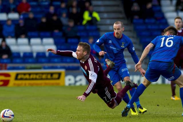 Ryan Stevenson loses his footing after passing Inverness CT midfielder Greg Tansey (right). Picture: SNS