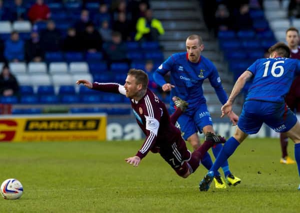 Ryan Stevenson loses his footing after passing Inverness CT midfielder Greg Tansey (right). Picture: SNS