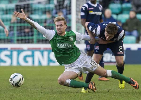 Richard Brittain brings Danny Handling's run to an abrupt halt. Picture: SNS