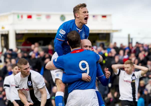 Dean Shiels and Jon Daly congratulate Nicky Law on his opener against Ayr United. Picture: SNS