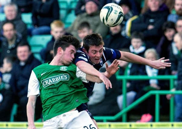 Sam Stanton battles it out with Ross Countys Richard Brittain during Saturdays encounter at Easter Road Picture:SNS