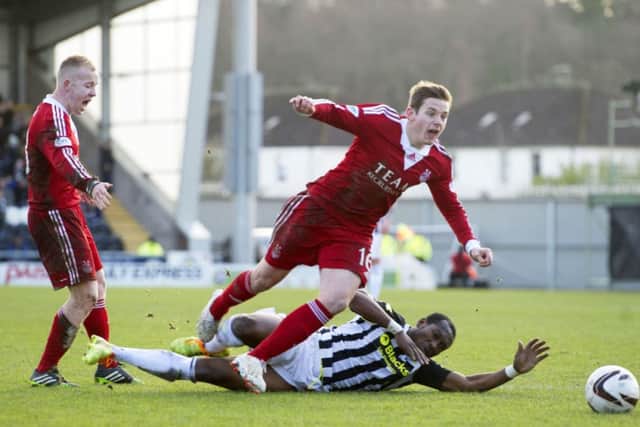 Peter Pawlett is brought down by St Mirren newcomer Eric Djemba Djemba Picture: SNS