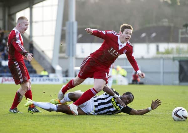 Peter Pawlett is brought down by St Mirren newcomer Eric Djemba Djemba Picture: SNS
