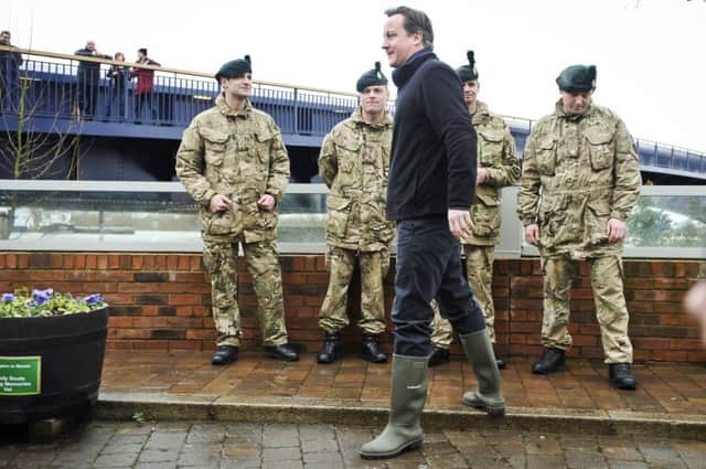 David Cameron chats with soldiers from the Royal Irish Regiment in Upton-Upon-Severn. Picture: PA