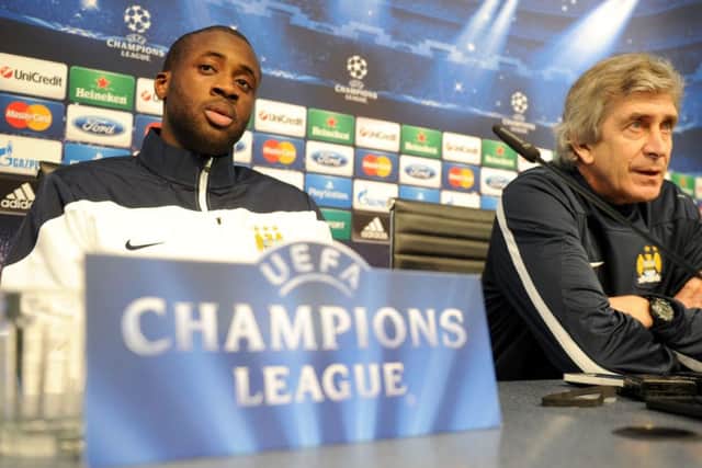 Manuel Pellegrini and Yaya Toure during the press conference at the Etihad Stadium. Picture: PA