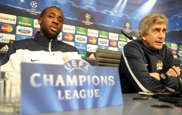 Manuel Pellegrini and Yaya Toure during the press conference at the Etihad Stadium. Picture: PA