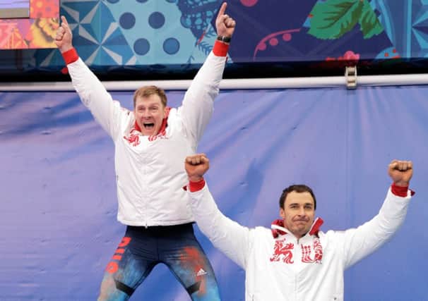 Alexander Zubkov, left, jumps for joy as he celebrates with Alexey Voevoda. Picture: Getty