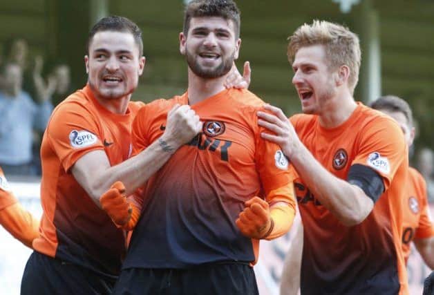 Dundee United players celebrate the goal that put them into the Scottish Cup quarter-finals. Picture: PA
