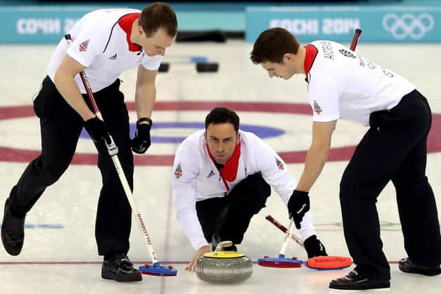 Michael Goodfellow and Scott Andrews sweep the ice in front of David Murdoch. Picture: AFP/Getty