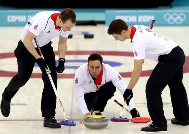 Michael Goodfellow and Scott Andrews sweep the ice in front of David Murdoch. Picture: AFP/Getty