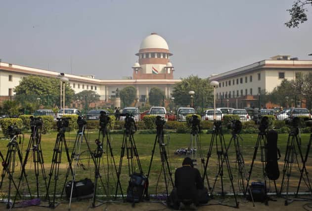 Cameras outside the court where death sentences on three men were commuted to life in prison. Picture: Reuters