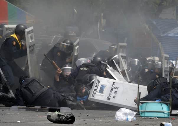 Police officers battle protesters near Government House in Bangkok. Picture: Reuters