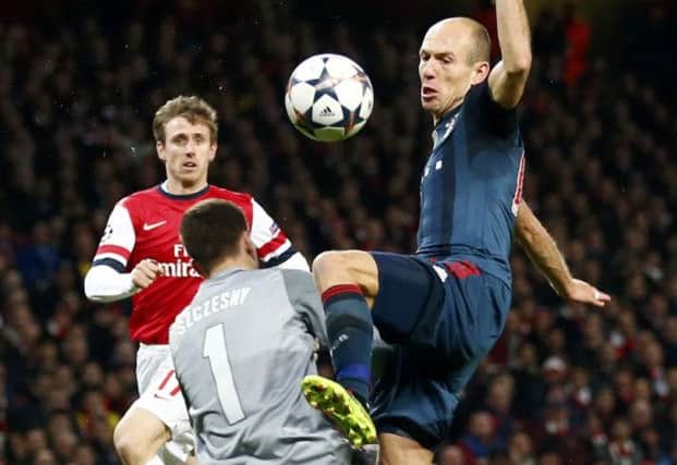 Arsenal goalkeeper Wojciech Szczesny brings down Arjen Robben to incur a red card. Picture: Reuters