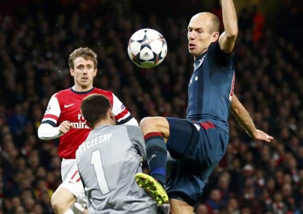 Arsenal goalkeeper Wojciech Szczesny brings down Arjen Robben to incur a red card. Picture: Reuters