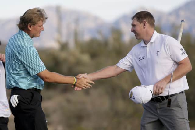 Ernie Els shakes hands with Stephen Gallacher after their first round match. Picture: AP