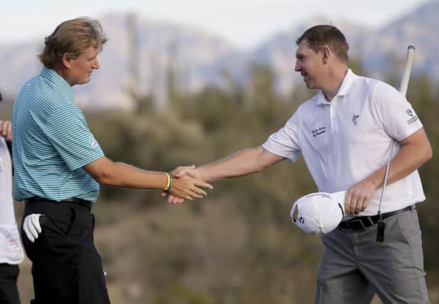 Ernie Els shakes hands with Stephen Gallacher after their first round match. Picture: AP