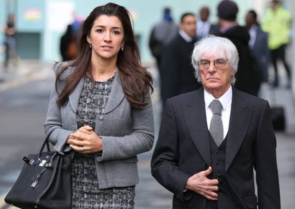 Bernie Ecclestone leaves the court with his wife Fabiana Flosi. Picture: Getty