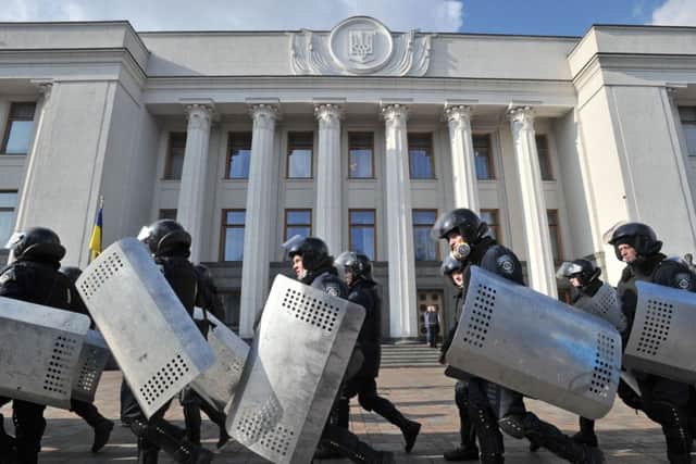 Police troops leave their position around Ukrainian Parliament in Kiev. Picture: AP